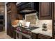 High-end kitchen featuring custom cabinetry, granite countertops, and a stainless steel Wolf range and hood at 22020 N Church Rd, Scottsdale, AZ 85255