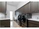 Spacious laundry room featuring modern washer and dryer, with ample cabinet and counter space at 22020 N Church Rd, Scottsdale, AZ 85255