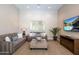 Cozy living room with neutral tones, comfortable sofas, and a modern entertainment center at 22020 N Church Rd, Scottsdale, AZ 85255