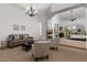 View of a spacious living room with a fireplace connecting to the main bedroom at 22020 N Church Rd, Scottsdale, AZ 85255