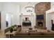 Spacious living room featuring a stone fireplace and modern chandelier at 22020 N Church Rd, Scottsdale, AZ 85255