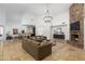 Spacious living room featuring a stone fireplace, open floor plan, and view into kitchen at 22020 N Church Rd, Scottsdale, AZ 85255