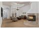Bright living room features a fireplace, built-in shelves, and elegant chandelier at 22020 N Church Rd, Scottsdale, AZ 85255
