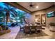 A comfortable outdoor dining area on a covered patio with a view of the pool at 22020 N Church Rd, Scottsdale, AZ 85255