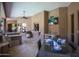 This outdoor kitchen has an outdoor bar, tv, sink, grill, and a dining table at 22020 N Church Rd, Scottsdale, AZ 85255