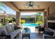 Outdoor living space with comfortable lounge seating, fireplace and views of the pool at 22020 N Church Rd, Scottsdale, AZ 85255