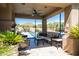 Covered patio seating area, providing stunning views of the basketball court, tennis court, and desert mountain backdrop at 22020 N Church Rd, Scottsdale, AZ 85255