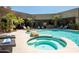 A backyard pool oasis featuring palm trees, lounge chairs, spa, and turquoise water offers a tranquil setting at 22020 N Church Rd, Scottsdale, AZ 85255