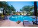 Luxury pool surrounded by lounge chairs and lush landscaping at 22020 N Church Rd, Scottsdale, AZ 85255