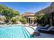 Backyard features a sparkling pool, spa, desert landscape, and lounge seating at 22020 N Church Rd, Scottsdale, AZ 85255
