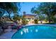 Beautiful pool featuring a waterfall with a relaxing lounge area and pool house at 22020 N Church Rd, Scottsdale, AZ 85255
