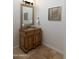 Elegant powder room featuring a decorative vanity, framed mirror, and tasteful wall art at 22020 N Church Rd, Scottsdale, AZ 85255