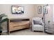 Comfortable sitting area featuring a plush chair, modern dresser, and stylish decor elements at 22020 N Church Rd, Scottsdale, AZ 85255