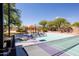 Multi-use sport court featuring basketball hoop, play structure, and mature landscaping at 22020 N Church Rd, Scottsdale, AZ 85255