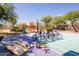 Well-equipped sport court with basketball hoop, bikes, cornhole game, and rackets at 22020 N Church Rd, Scottsdale, AZ 85255