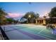 Well-lit tennis and basketball court and a charming covered patio, ideal for recreation and entertainment at 22020 N Church Rd, Scottsdale, AZ 85255