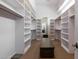 Spacious walk-in closet with built-in shelving and ample storage space at 22020 N Church Rd, Scottsdale, AZ 85255