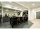 Wet bar features a backsplash, marble counters and modern fixtures, creating a focal point for the entertainment space at 2315 E Mine Creek Rd, Phoenix, AZ 85024