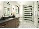 Modern bathroom with patterned tile floor, glass shower, and stylish wood vanity at 2315 E Mine Creek Rd, Phoenix, AZ 85024