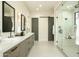Spacious bathroom featuring double vanities, a glass-enclosed shower, and contemporary design at 2315 E Mine Creek Rd, Phoenix, AZ 85024