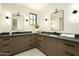 Spacious bathroom featuring dual sinks, stone countertops, decorative lighting, and contemporary fixtures at 2315 E Mine Creek Rd, Phoenix, AZ 85024