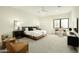 The main bedroom features large windows, a ceiling fan, and modern furniture at 2315 E Mine Creek Rd, Phoenix, AZ 85024