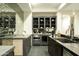 The kitchen boasts stainless steel appliances, mirrored backsplash, custom cabinetry and a wine fridge at 2315 E Mine Creek Rd, Phoenix, AZ 85024