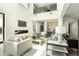 Bright living room with fireplace, soaring ceilings, and comfortable seating arrangement at 2315 E Mine Creek Rd, Phoenix, AZ 85024