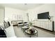 Inviting living room featuring a white sofa, modern furniture, and a sleek entertainment center at 2315 E Mine Creek Rd, Phoenix, AZ 85024