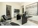 A modern office has hardwood floors, natural light, and a contemporary black desk at 2315 E Mine Creek Rd, Phoenix, AZ 85024