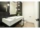 A modern powder room featuring unique wall tiles, modern fixtures, and updated finishes at 2315 E Mine Creek Rd, Phoenix, AZ 85024