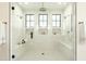 Modern walk-in shower with tile surround, a rainfall showerhead, and integrated bench seating at 2315 E Mine Creek Rd, Phoenix, AZ 85024