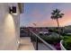 Balcony view captures colorful sunset, city buildings and lush landscape, framed by modern railing at 2326 E Gardenia Dr, Phoenix, AZ 85020