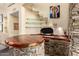 Charming bar area featuring stone accents, custom-built counter, glass shelving, and artistic decor, ideal for hosting guests at 2326 E Gardenia Dr, Phoenix, AZ 85020