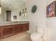 Chic bathroom featuring a custom vanity with a round window for natural light at 2326 E Gardenia Dr, Phoenix, AZ 85020