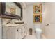 Charming bathroom with decorative vanity, stone sink, and unique fixtures, plus artistic paintings on the wall at 2326 E Gardenia Dr, Phoenix, AZ 85020