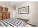 Light filled bedroom with a wooden accent bench and a queen-sized bed with patterned comforter at 2326 E Gardenia Dr, Phoenix, AZ 85020