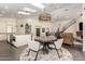 Contemporary dining area adjacent to the kitchen, featuring modern lighting and stair access at 2326 E Gardenia Dr, Phoenix, AZ 85020