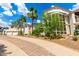 Grand home featuring a circular driveway, mature palm trees, and lush desert landscaping at 2326 E Gardenia Dr, Phoenix, AZ 85020