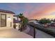 Stunning exterior view showcasing a balcony overlooking a scenic driveway and desert landscape at sunset at 2326 E Gardenia Dr, Phoenix, AZ 85020