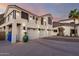 Exterior of a two-story home boasts a three-car garage, balcony, and a landscaped yard at 2326 E Gardenia Dr, Phoenix, AZ 85020