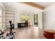 Spacious home gym with wood floors, exposed beams, and large windows at 2326 E Gardenia Dr, Phoenix, AZ 85020