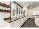 Bright kitchen with white cabinetry, built-in oven, and a countertop that looks out through a set of windows at 2326 E Gardenia Dr, Phoenix, AZ 85020