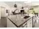 Open kitchen layout with island seating, and a full view of the living room and outdoor entertainment area at 2326 E Gardenia Dr, Phoenix, AZ 85020