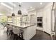 Modern kitchen with a large island, seating, stainless steel appliances, and lots of natural light at 2326 E Gardenia Dr, Phoenix, AZ 85020