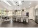 Bright, open kitchen with island seating, stainless steel appliances, and access to the dining area at 2326 E Gardenia Dr, Phoenix, AZ 85020