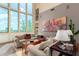 Bright living room with high windows, comfortable seating, and unique artwork, creating a welcoming and stylish space at 2326 E Gardenia Dr, Phoenix, AZ 85020