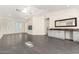 Open-concept living area with hardwood floors, bar with sink and countertop, and lots of light at 2326 E Gardenia Dr, Phoenix, AZ 85020