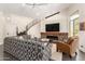 Stylish living room with a fireplace, comfortable seating, and a staircase, creating a cozy and inviting atmosphere at 2326 E Gardenia Dr, Phoenix, AZ 85020