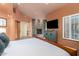Spacious main bedroom features a stone fireplace and a flat screen television at 2326 E Gardenia Dr, Phoenix, AZ 85020